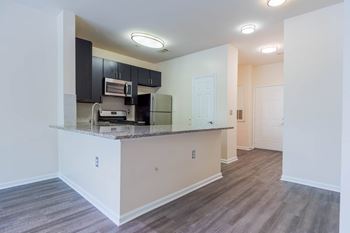 A kitchen area with a counter and cabinets.